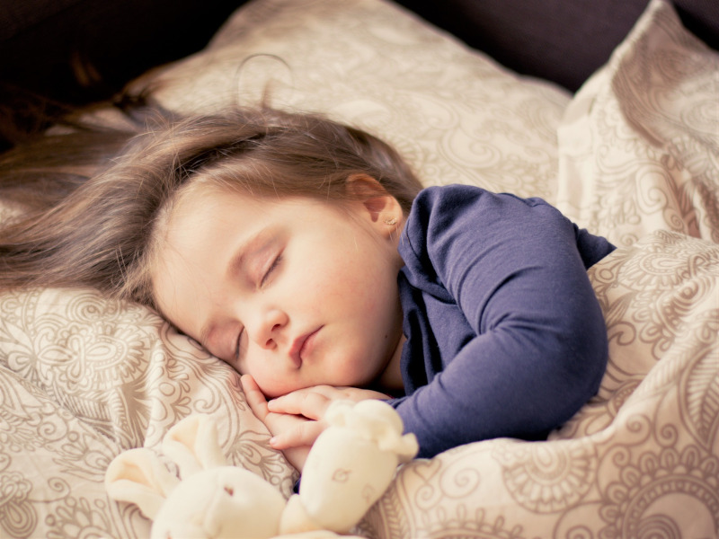 Niño pequeño durmiendo en la cama